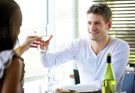 Portait Of A Couple Celebrating Something At A Restaurant Stock Photo