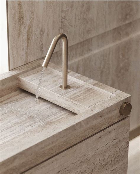 A Bathroom Sink With A Faucet Running From It S Side To The Wall