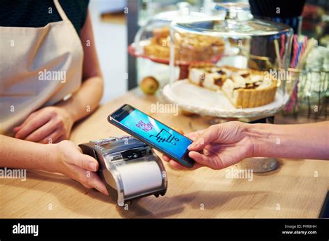 Customer Paying Cashless With Smartphone In A Cafe Stock Photo Alamy