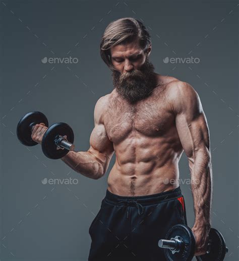 Strong Bodybuilder With Dumbells And Naked Torso Posing In Studio Stock