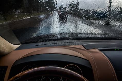 Car Driving In The Rain View From The Inside Raindrops On The