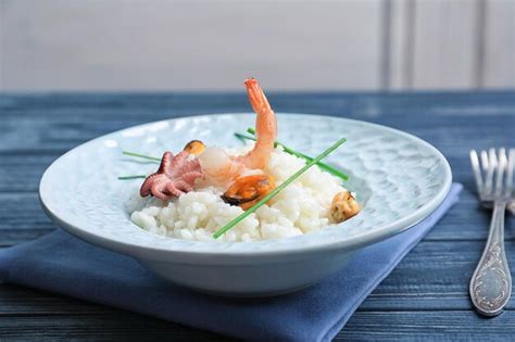 Premium Photo Dish With Delicious Seafood Risotto On Wooden Table