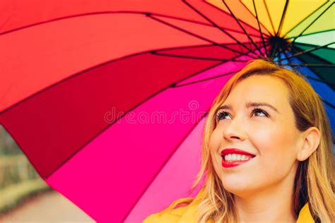 Cheerful Pretty Girl Holding Multi Colored Umbrella While Strolling