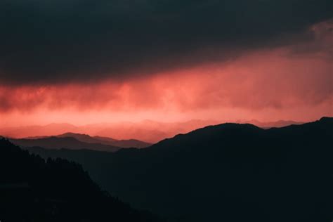 A red and black sky over a mountain range photo – Free Nature Image on ...