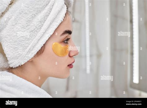 Beautiful Woman With Eye Patches In White Bathrobes In Bathroom Stock