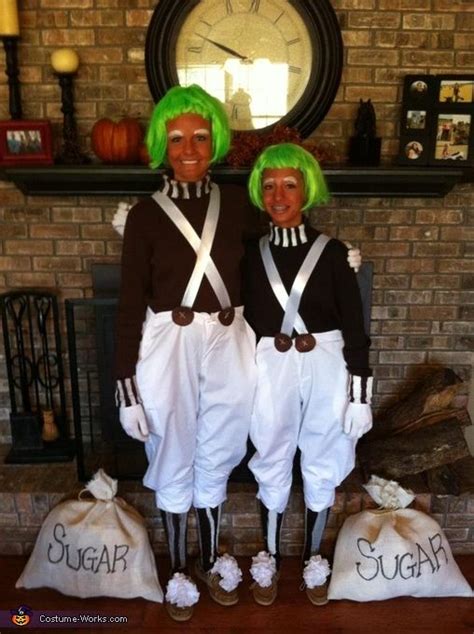 Two People Dressed In Costumes Standing Next To Each Other