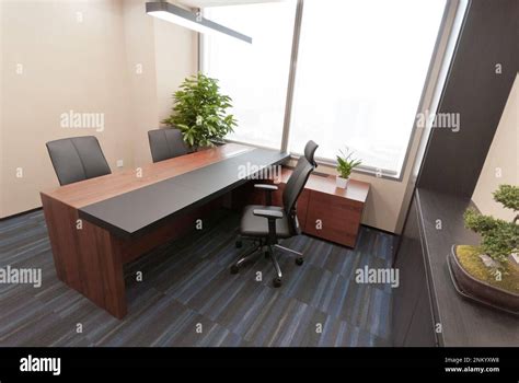 A Modern Office Space With A Green Plant In The Corner Providing A