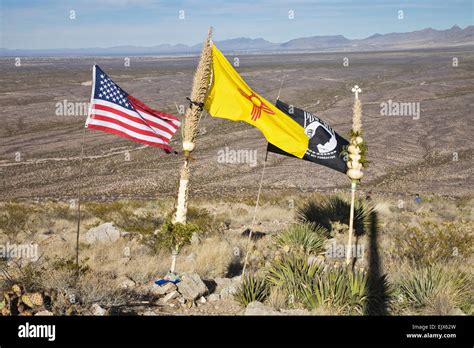 A US flag, a New Mexico flag an MIA flag and a traditional staff called ...