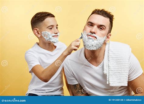 Father And Son Shaving On Yellow Background Stock Photo Image Of Care