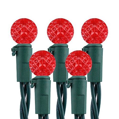 four red christmas lights on green wire with white bulbs and plugged in ...