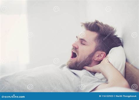 Handsome Young American Male Yawn Sleeping In Bed At Home Stock Image