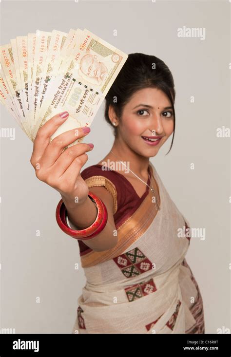 Woman Holding Indian Five Hundred Rupee Notes And Smiling Stock Photo