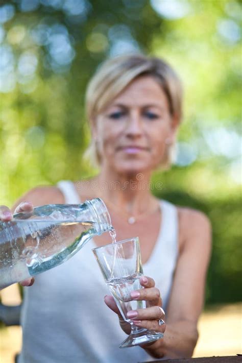 Cute Woman Pouring Water In A Glass Stock Photo Image Of Girl Garden