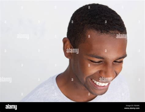 Close up portrait of a laughing black guy posing against white background Stock Photo - Alamy