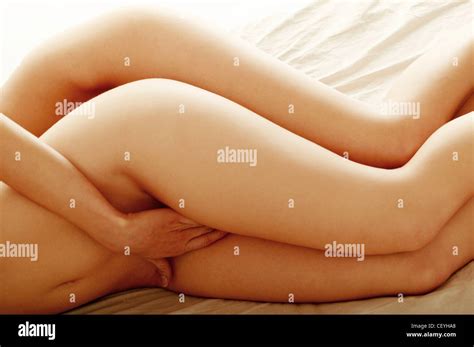 Two Nude Females Lying On Bed Side By Side Hugging And Touching Stock Photo Alamy
