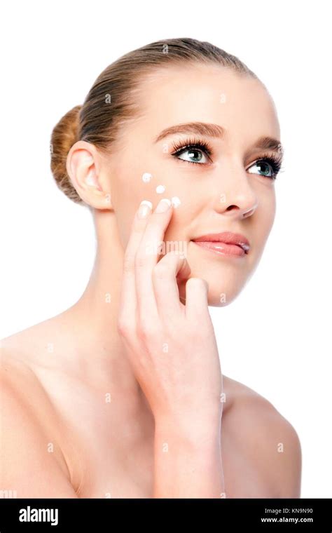 Beautiful Woman Applying Moisturizing Facial Skincare Treatment Cream