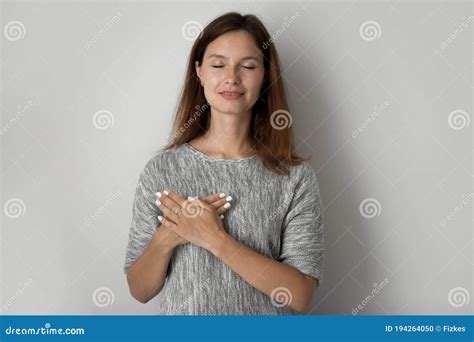 Grateful Young Woman Keep Hands At Heart Feeling Thankful Stock Photo