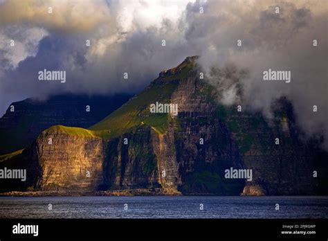 The Faroe Island Of Kalsoy In The Atlantic Ocean With Sun And Clouds