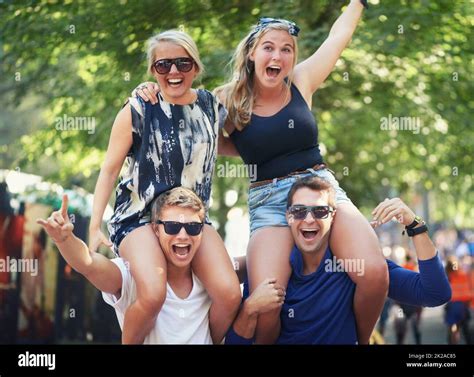 Getting A Better Look At The Band Two Guys Carrying Their Girlfriends On Their Shoulders At A