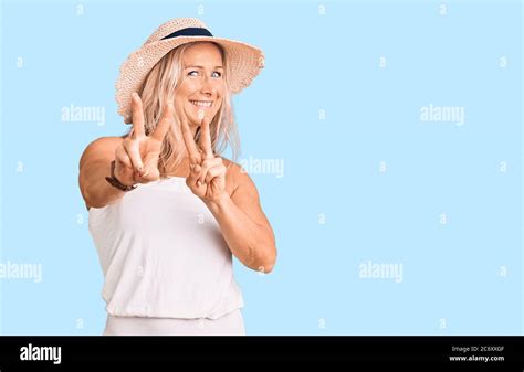 Middle Age Fit Blonde Woman Wearing Summer Hat Smiling Looking To The