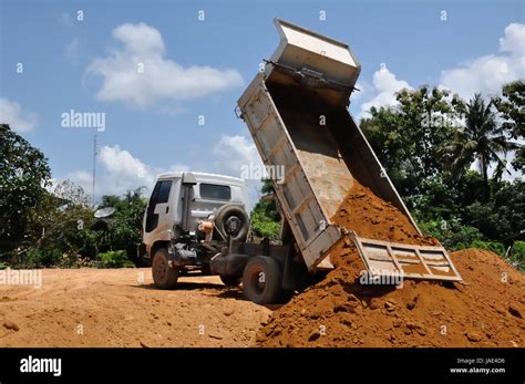 White Dump Truck Dumping Soil In My Home Ground Stock Photo Alamy