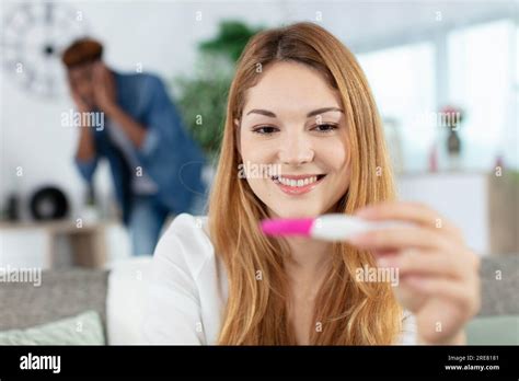 Worried Frustrated Man And Happy Woman With Positive Pregnancy Test