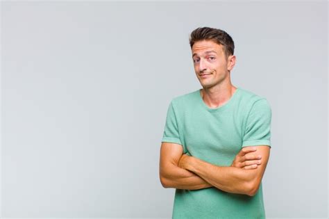 Premium Photo | Young handsome man shrugging, feeling confused and ... 