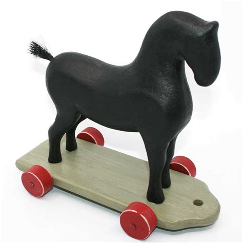 BLACK WOODEN HORSE ON WHEELS | Marguerite Bourgeoys Museum & Notre-Dame-de-Bonsecours Chapel