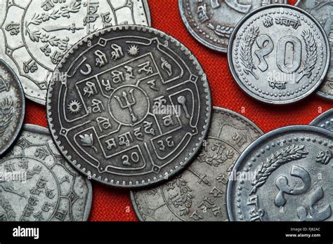 Coins of Nepal. Hindu trishul depicted in the Nepalese rupee coins ...