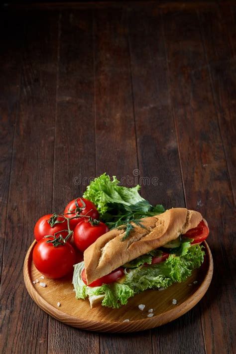 Fresh Sandwich With Lettuce Tomatoes And Cheese Served On Wooden Plate