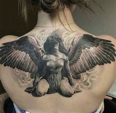 The Back Of A Woman S Neck With An Angel Tattoo On It