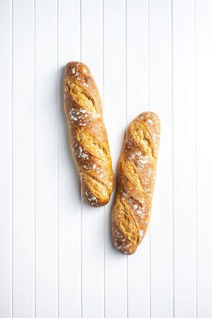 Premium Photo Two Crispy Fresh Baguettes On A White Table Top View