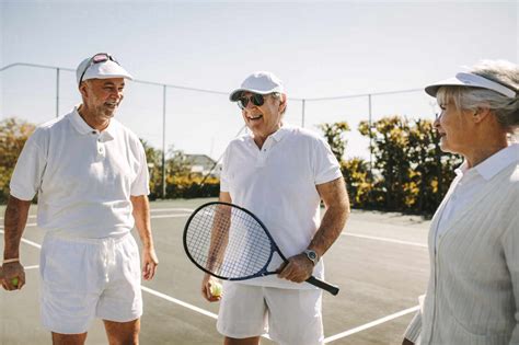 Senior People Playing Tennis On A Sunny Day Cheerful Old Men Standing