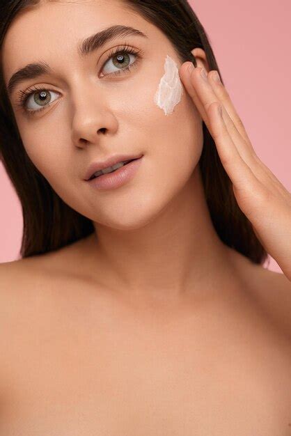 Premium Photo Woman With Cosmetic Cream On Face