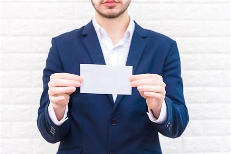 Premium Photo Midsection Of Businessman Holding Blank Paper