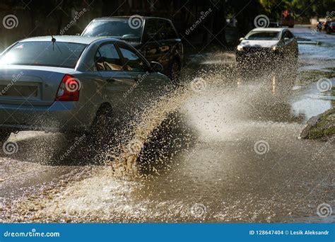 Driving Cars On A Flooded Road During Floods Caused By Rain Storms