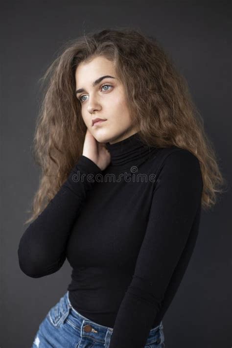 Front Photo Of A Feminity Young Woman With Curly Hair Wear Black