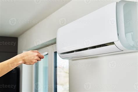 Hand Adjusting Temperature On Air Conditioner Stock Photo At