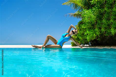 Sexy Woman In Bikini Near The Pool At Maldives Tropical Sand Beach