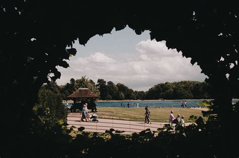 People walking on embankment near river · Free Stock Photo