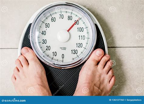 Close Up Weighing Scale Men Standing On Weigh Scales Stock Photo