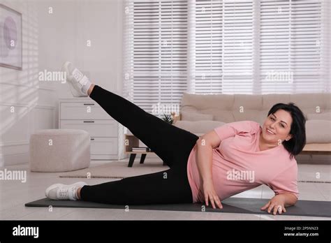 Overweight Mature Woman Doing Exercise At Home Stock Photo Alamy