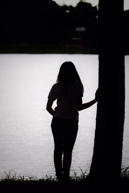 Premium Photo Rear View Of Woman Standing At Lakeshore During Dusk