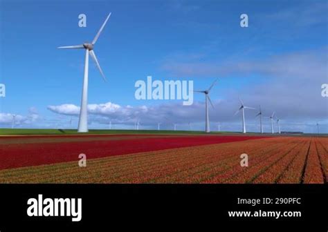 Majestic Windmill Turbines Stand Tall Against The Backdrop Of Colorful