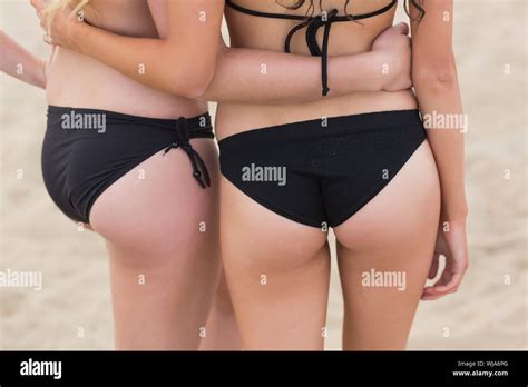 Rear View Mid Section Of A Slender Woman In Black Bikini Bottom With