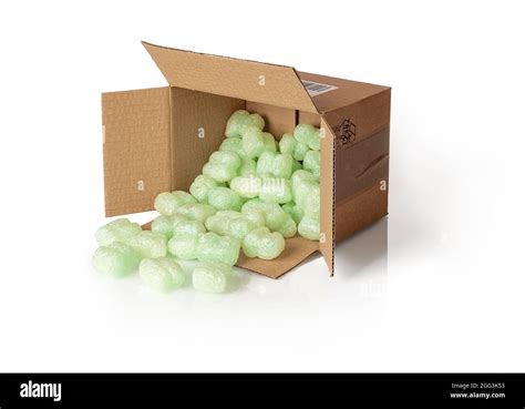 Shipping Peanuts Spilling Out Of The Parcel Box Laying On Its Side Isolated On A White Brown