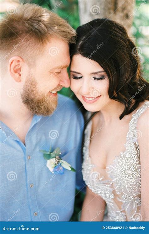 Bride And Groom Touch Their Foreheads To Each Other Portrait Stock