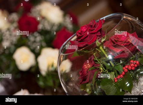 Decorative red rose in glass bowl with more flowers in background Stock ...