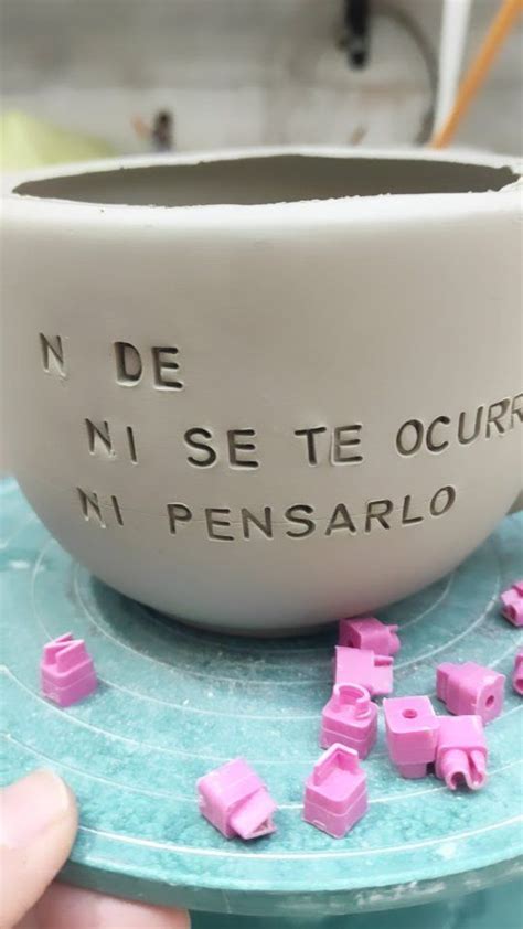 A White Bowl With Pink Cubes In It Sitting On Top Of A Blue Plate