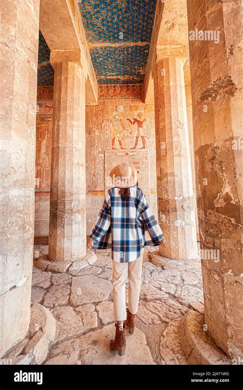 Happy Woman Traveler Explores The Ruins Of The Ancient Egyptian